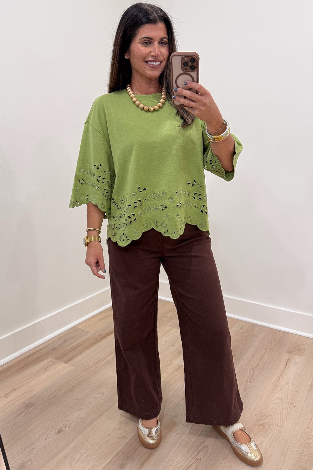 solid grass green floral eyelet accents scalloped hem crew neckline half sleeve knit top