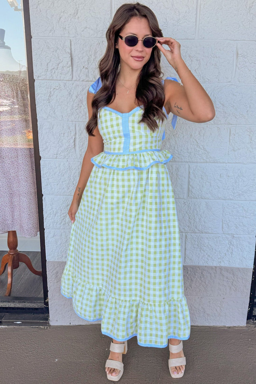honeydew green gingham print with light blue trim details peplum style sleeveless midi dress