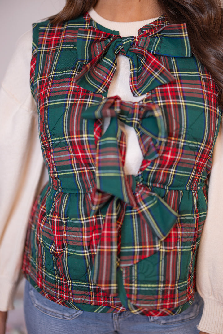 Women's green and red plaid vest with bow tie front closure and floral stitching by Entro showing up close front view