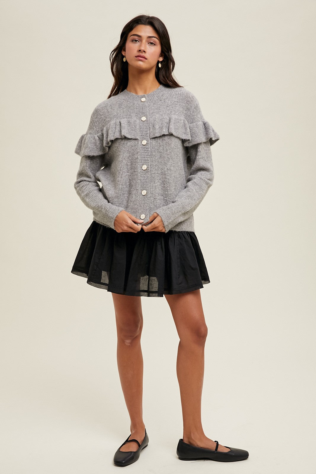 Women's grey knit sweater with a ruffle across the front chest and back shoulders by Wishlist showing full front view