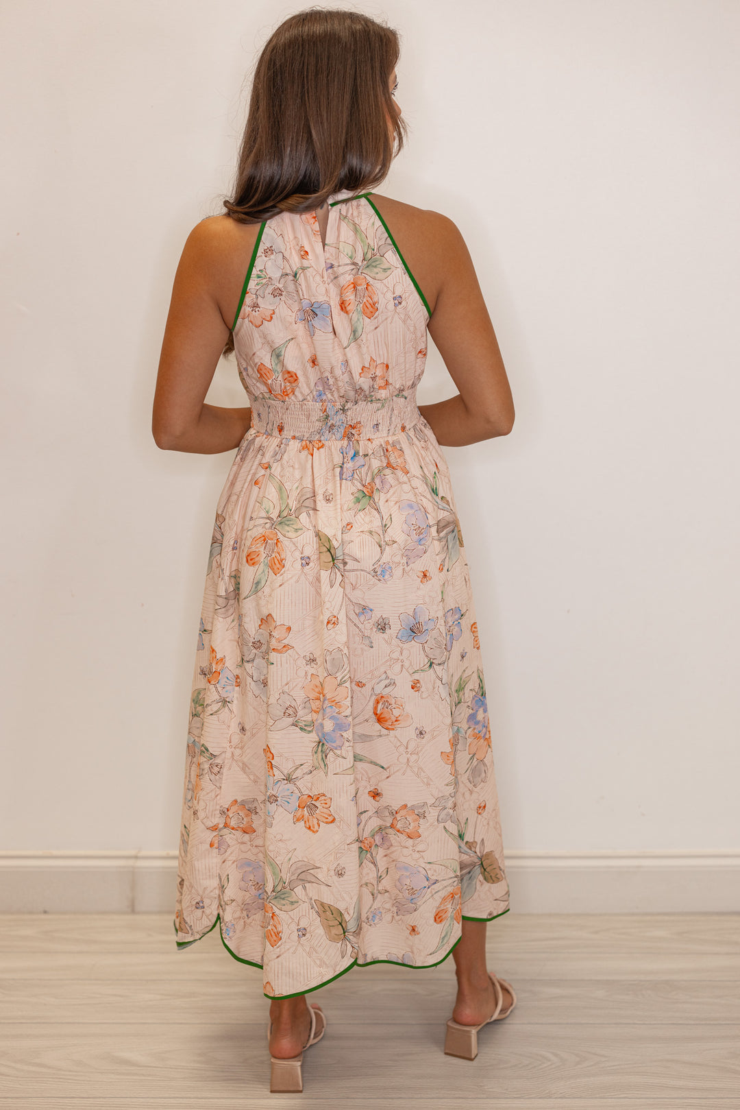 Women's blush floral print midi dress with green stripes and a tulip hem by Entro showing full back view