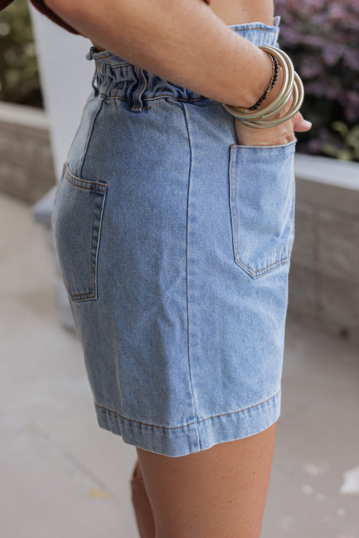Blue high rise denim shorts with ruffle trimmed waistband by Hidden showing up close side view