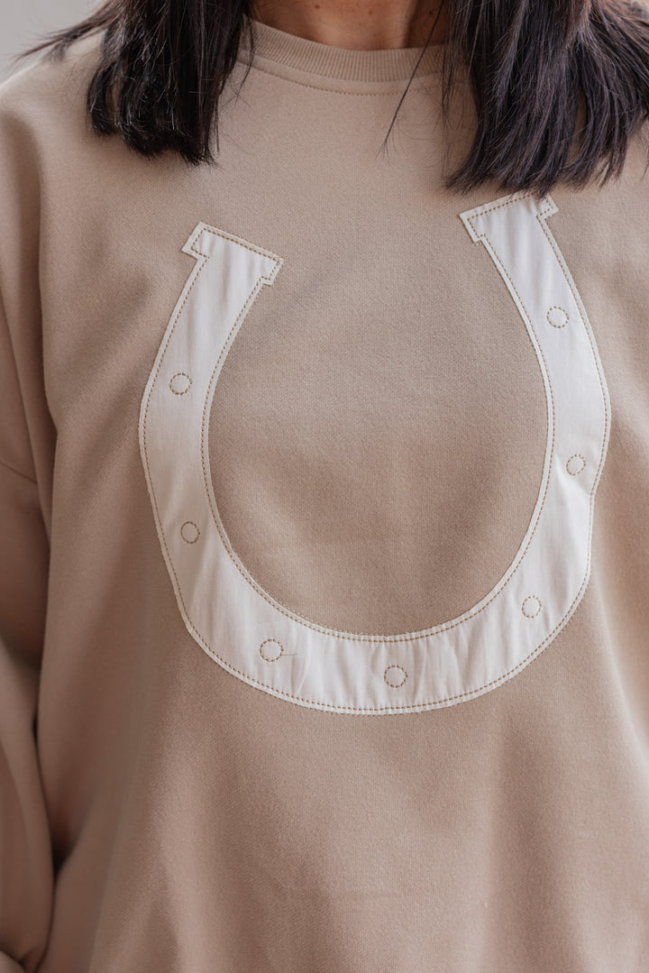 Women's taupe terry knit pullover sweatshirt with a white horseshoe on front by Wishlist showing up close front view