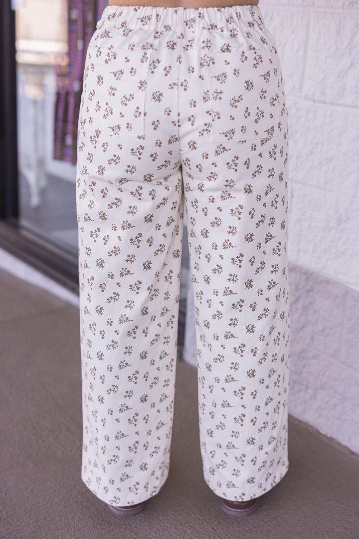Women's cream denim pants with mocha and olive floral print by Wishlist showing back view