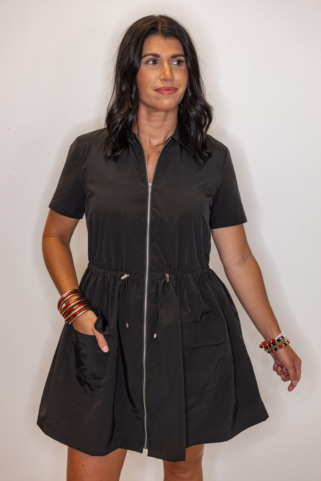 Women's black cinch waist dress by Karlie showing front pocket details