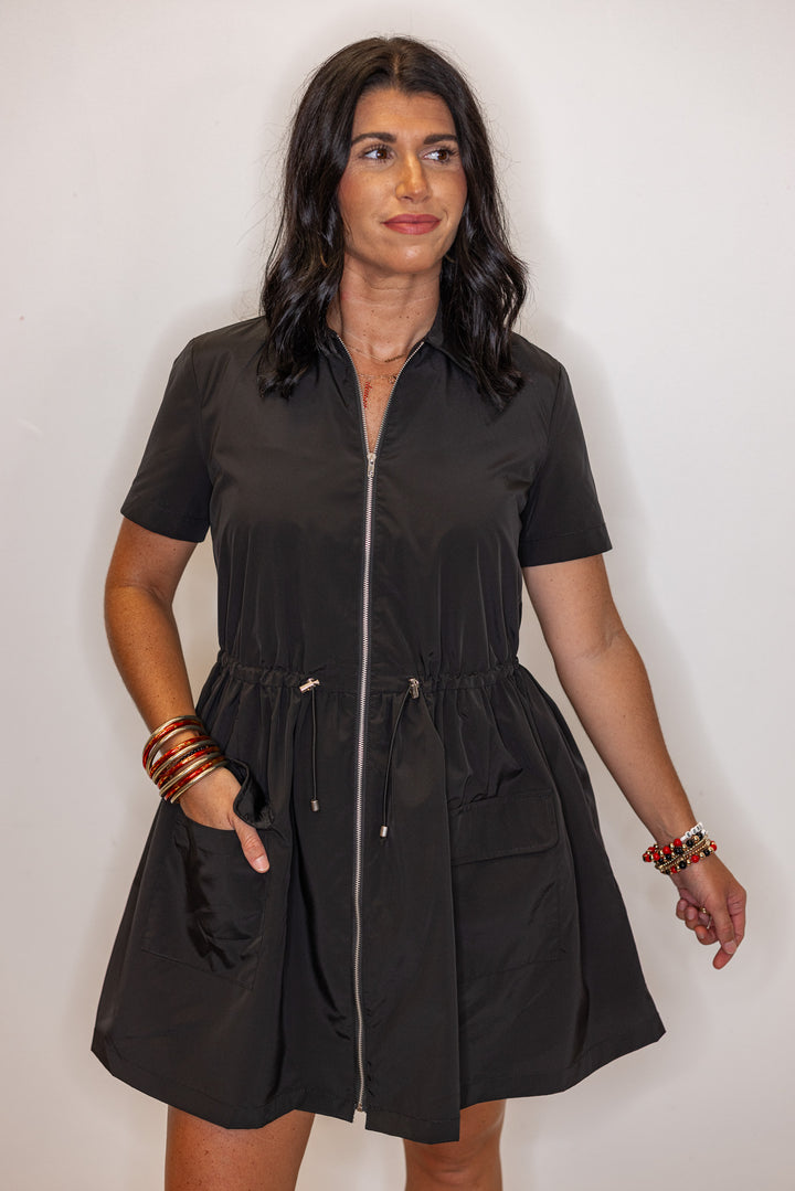 Women's black cinch waist dress by Karlie showing front pocket details