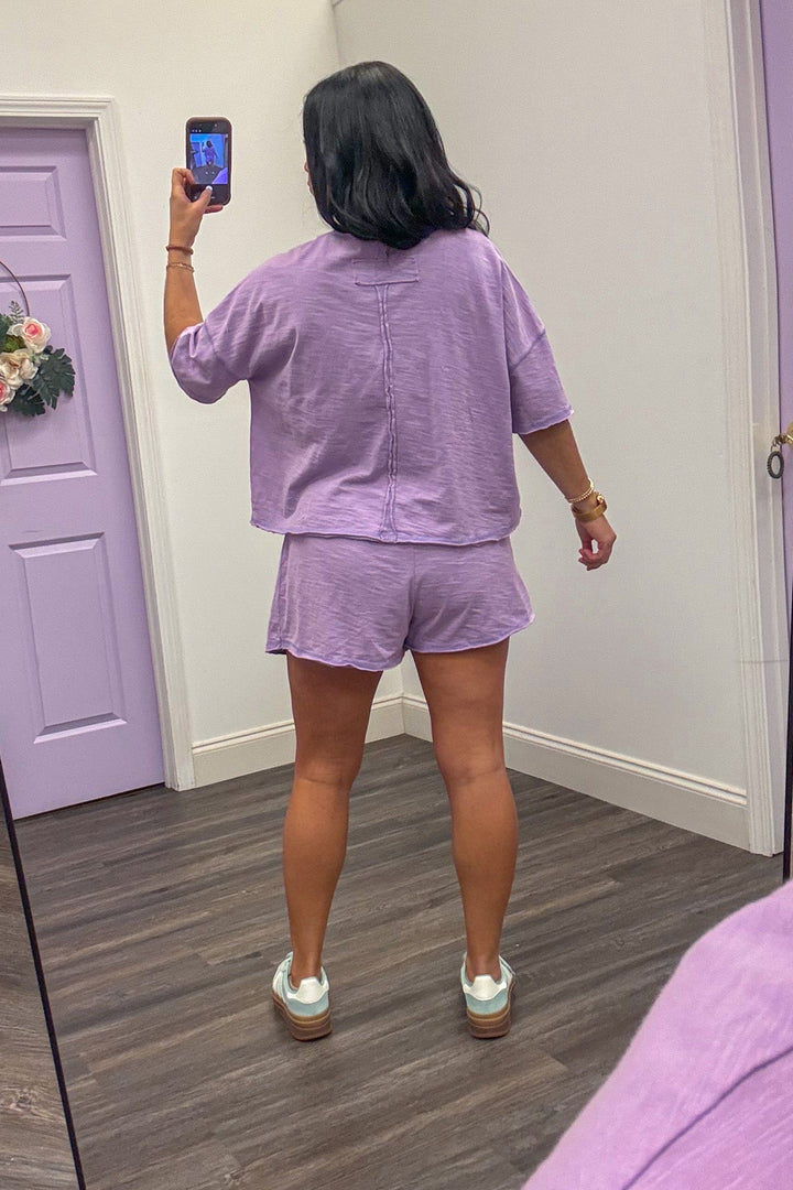 Back view of Women's lavender athleisure skort set with matching top