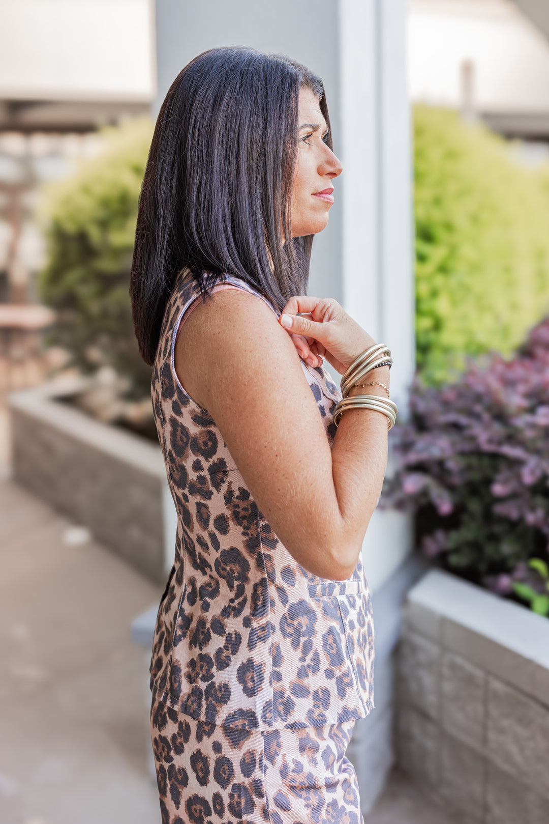 Women's black, brown and tan leopard print button front denim vest by Karlie showing up close side view