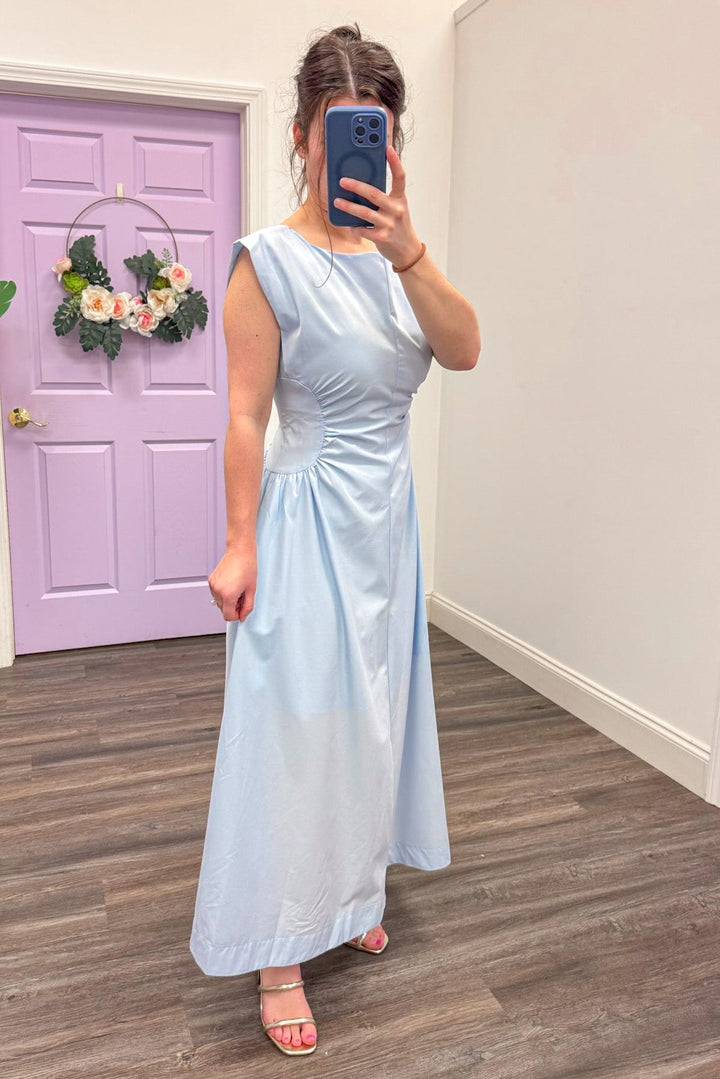 Side view of Women's light blue cinched panel waist midi dress