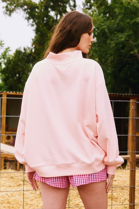 Women's pink sweatshirt with embroidered "Blessed" on front by Bucketlist showing back view