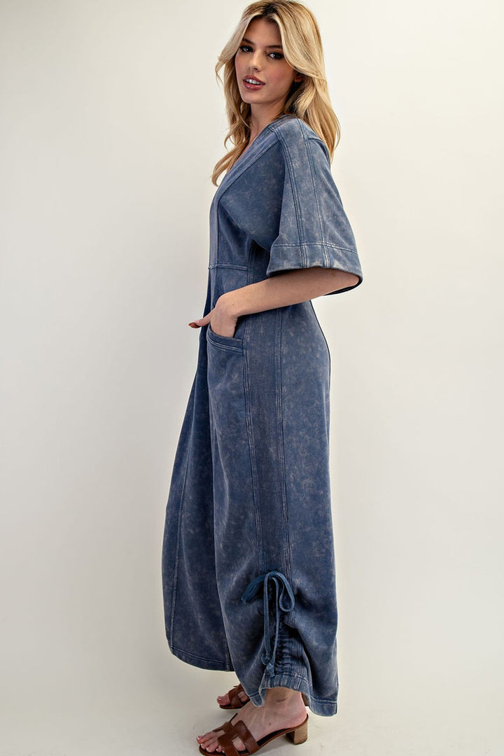 Women's knit jumpsuit in washed blue denim color with adjustable length by ee:some showing side view