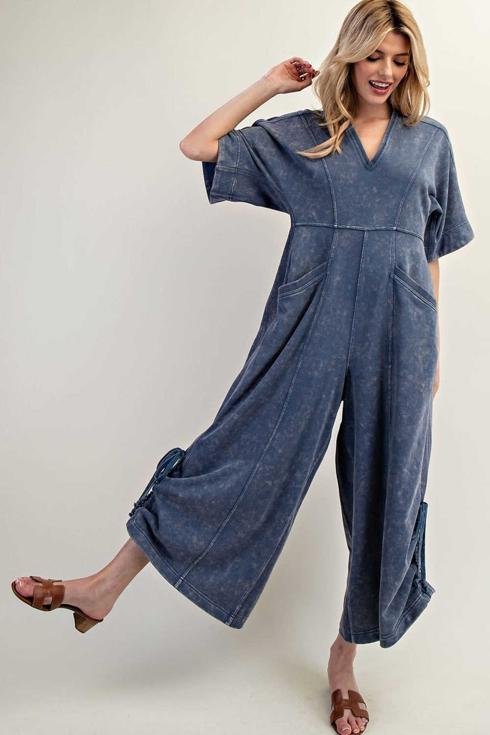 Women's knit jumpsuit in washed blue denim color with adjustable length by ee:some showing full front view