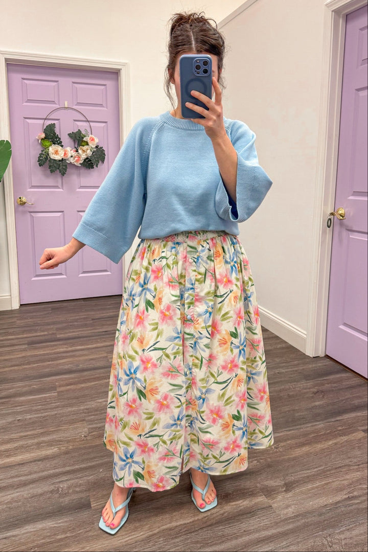 Women's cream floral midi skirt with multi-color print and full button-front detail