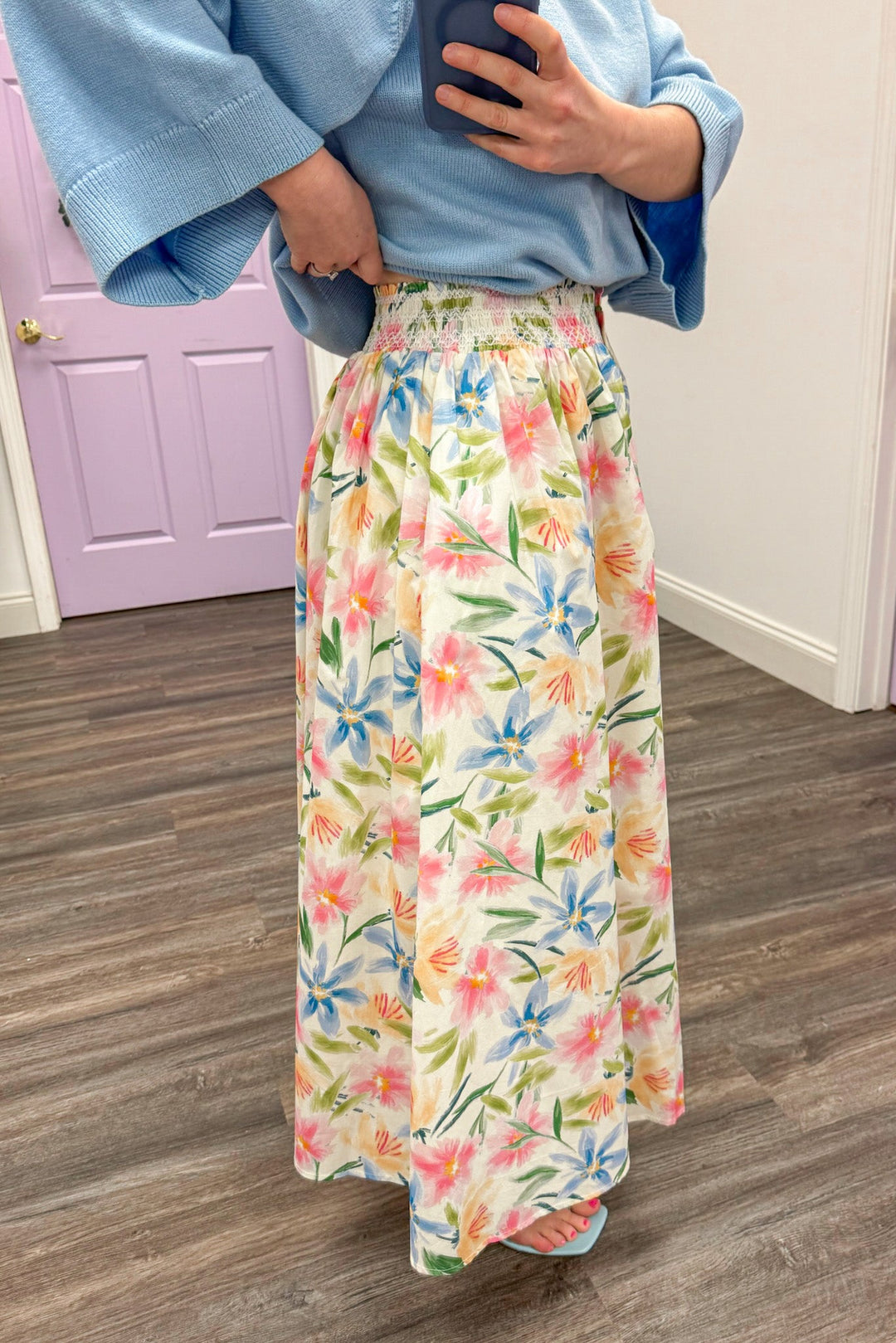 Women's cream floral midi skirt with multi-color print and full button-front detail showing smocked waistline