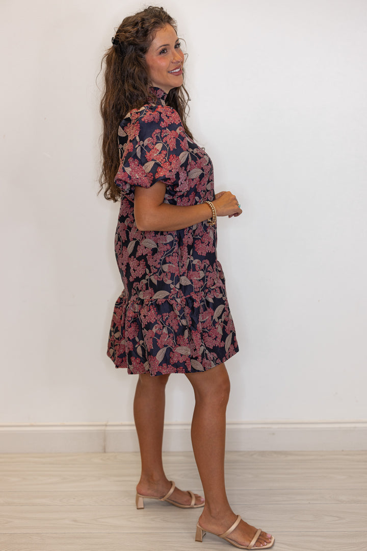 side view of Woman's burgundy and black floral printed dress