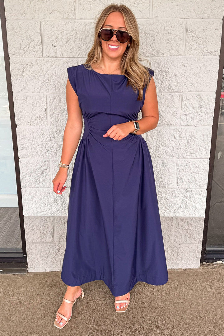 solid navy blue sleeveless midi dress with ruched side panels at waist