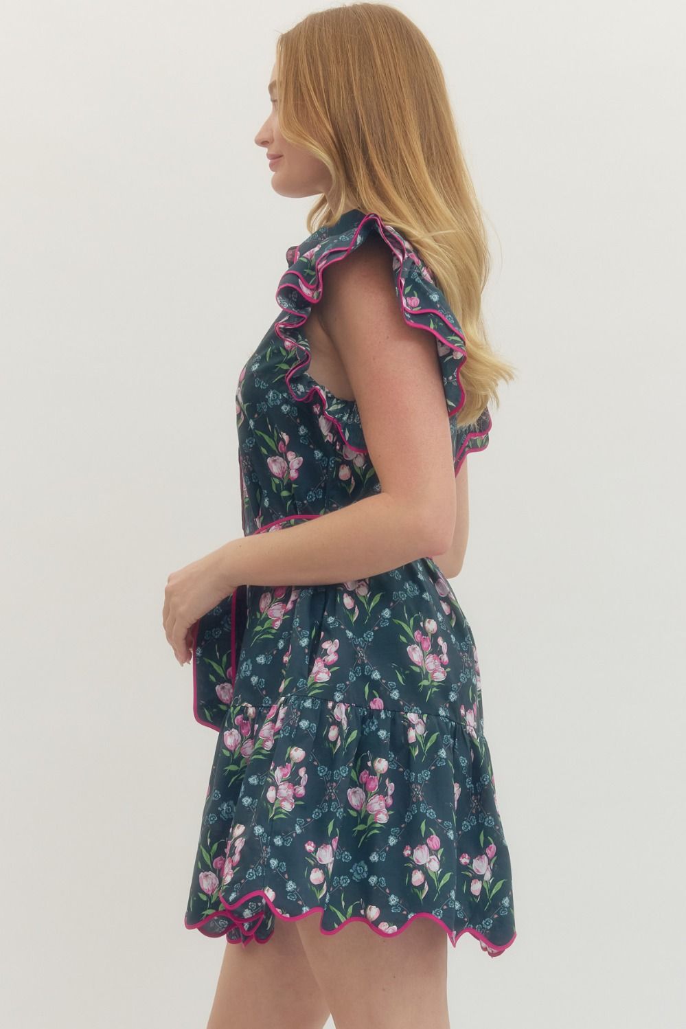 Women's navy button down dress with pink florals and hot pink scalloped trim by Entro showing side view