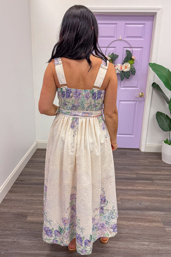 back view of cream eyelet sleeveless midi dress with lavender and teal floral print and smocked back