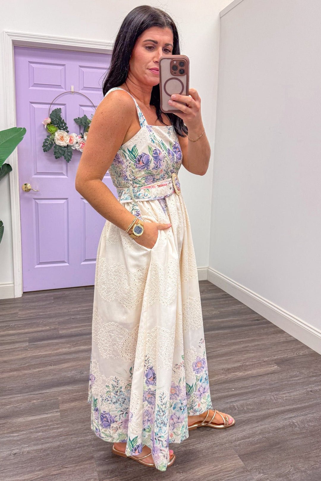 Side view of cream eyelet sleeveless midi dress with lavender and teal floral