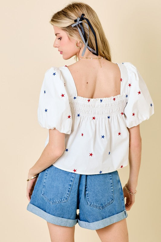 Day + Moon Off white poplin babydoll top with red and blue embroidered stars