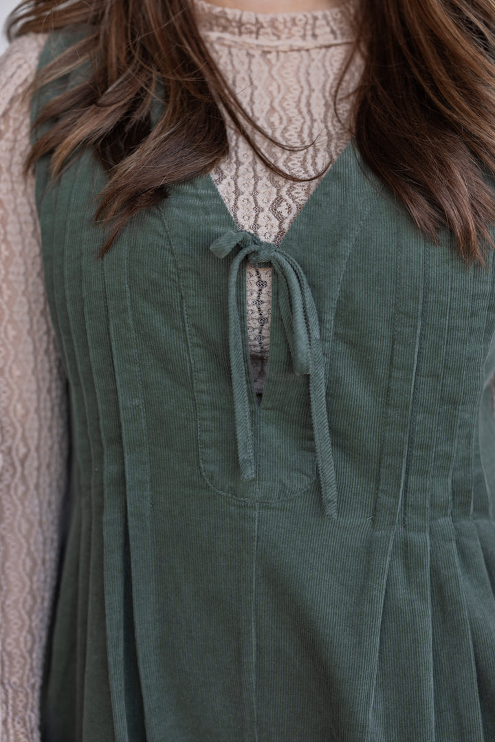 Women's olive green corduroy romper with ruched bodice by Wishlist showing bow tie v neck