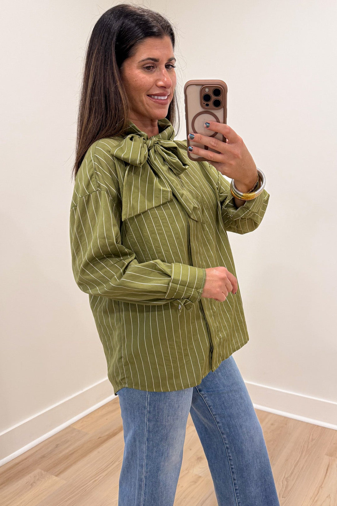 olive green and cream striped mock neck button cuffed long sleeve flap covered button front top