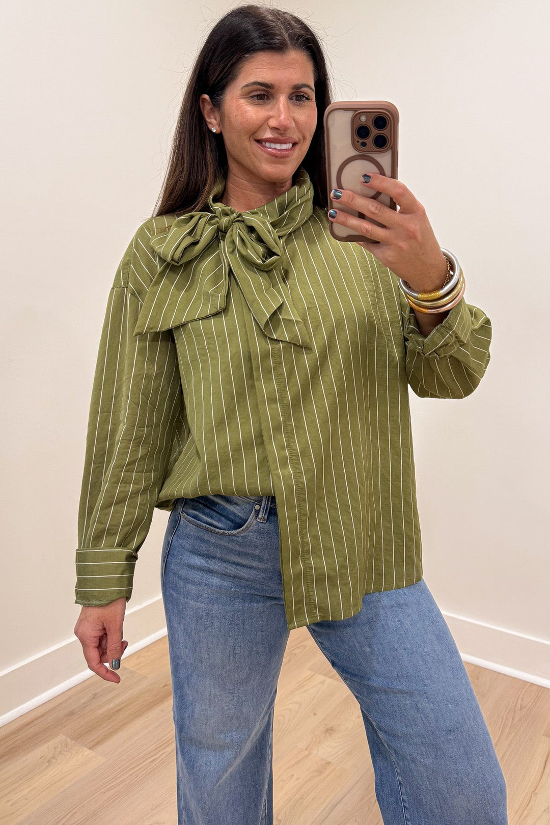 olive green and cream striped long sleeve flap covered button front top with adjustable bow tie mock neckline