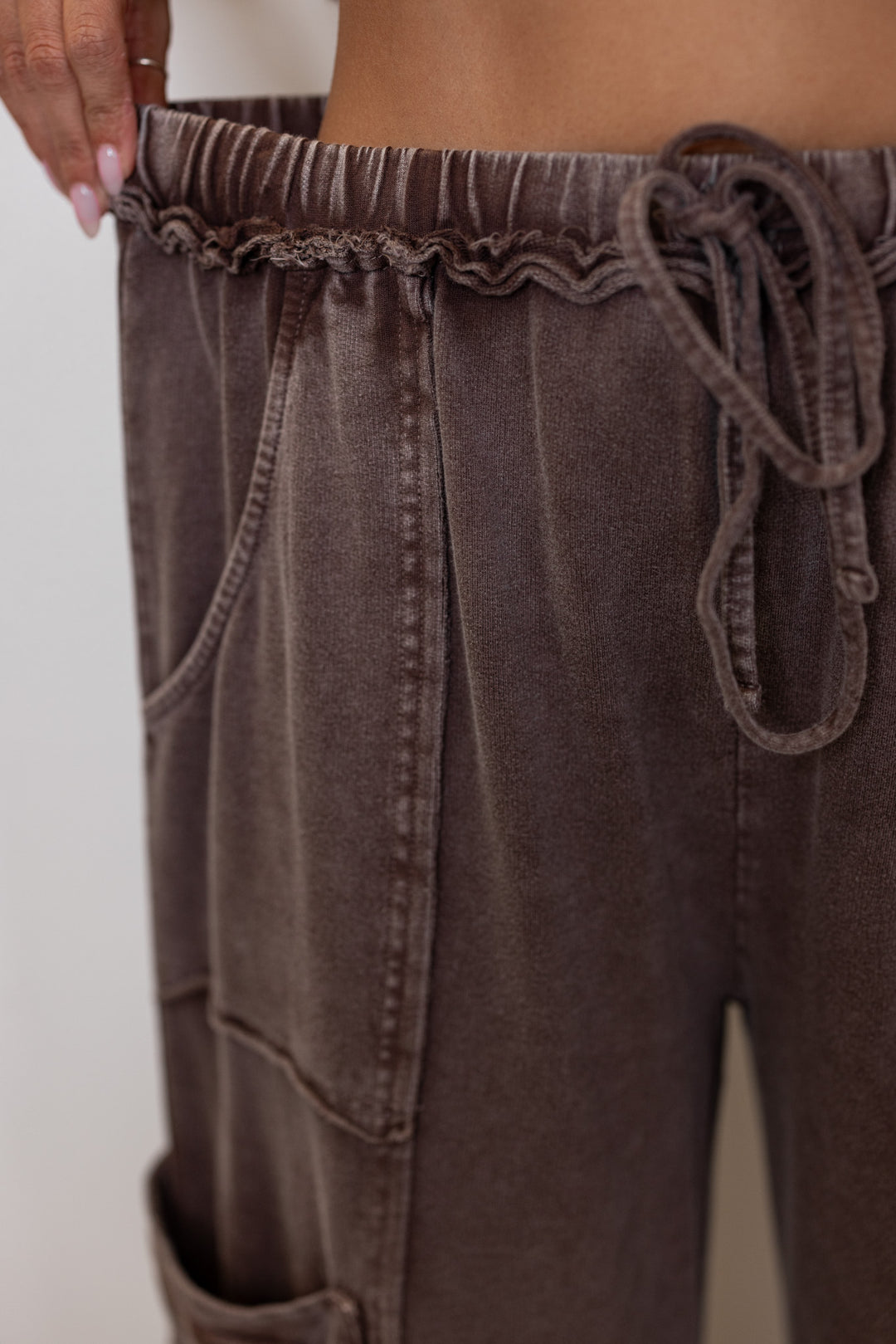 Women's mineral washed dark mocha terry knit exaggerated wide leg pants by Easel showing elastic waistband with self tie drawstring