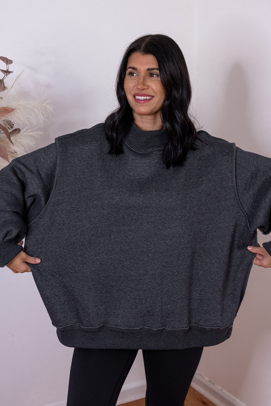 Women's charcoal reversible mock neck sweatshirt by Bucketlist showing oversized fit