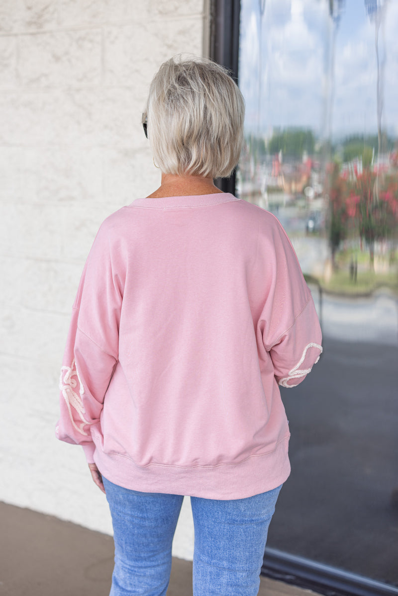 pink white stitched bow sweatshirt