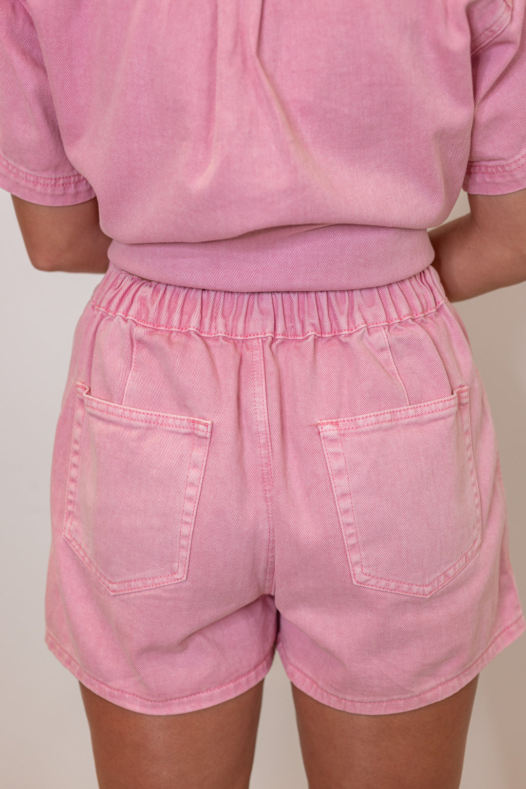 Bubblegum pink washed denim skort with wrap around style front by Wishlist showing back view