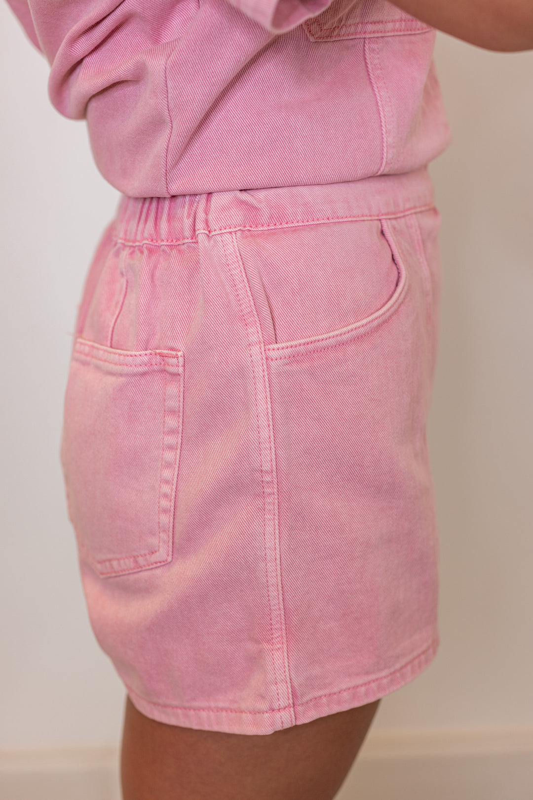 Bubblegum pink washed denim skort with wrap around style front by Wishlist showing side view
