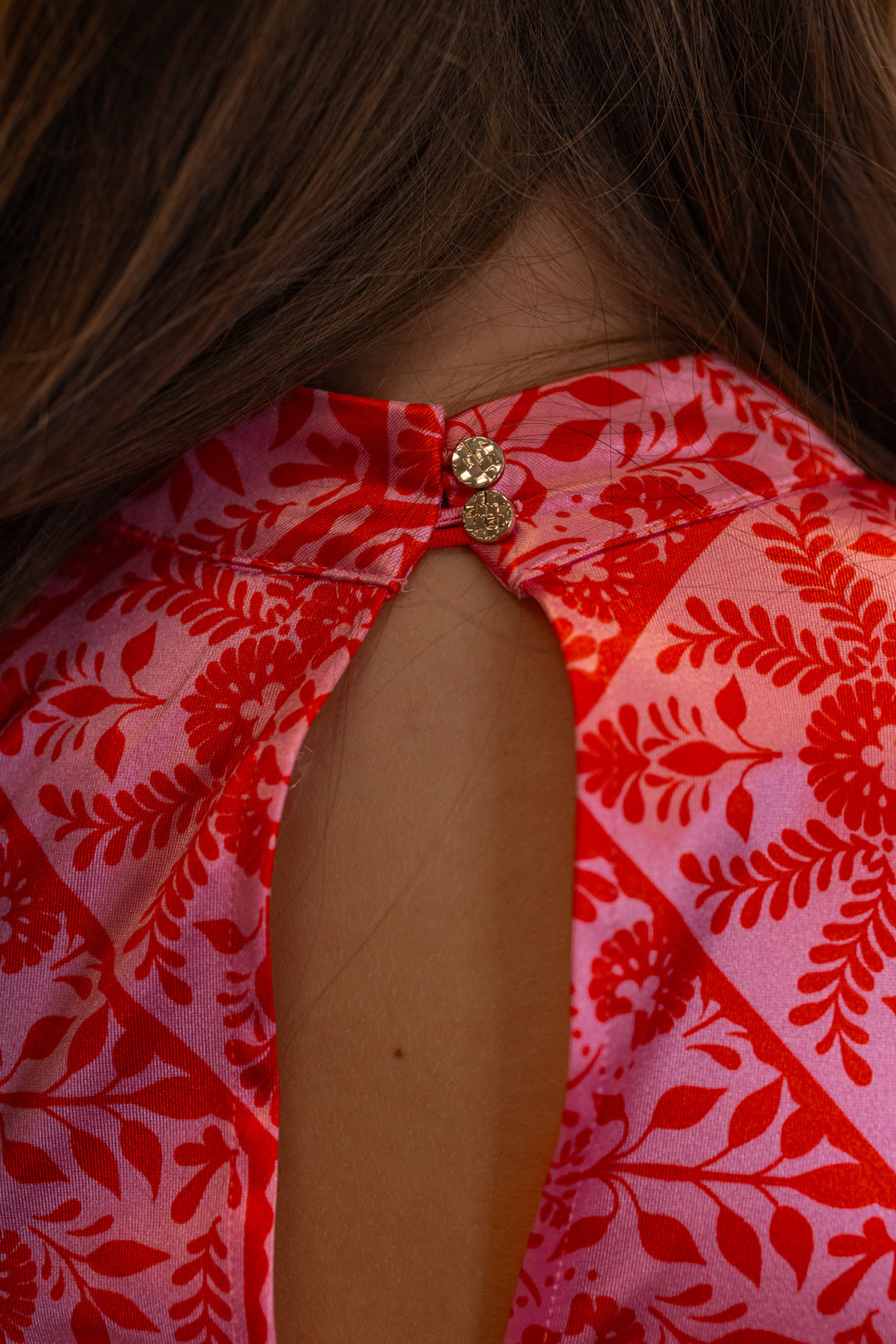 Women's pink and red floral print halter maxi dress by Karlie showing up close view of keyhole double button closure