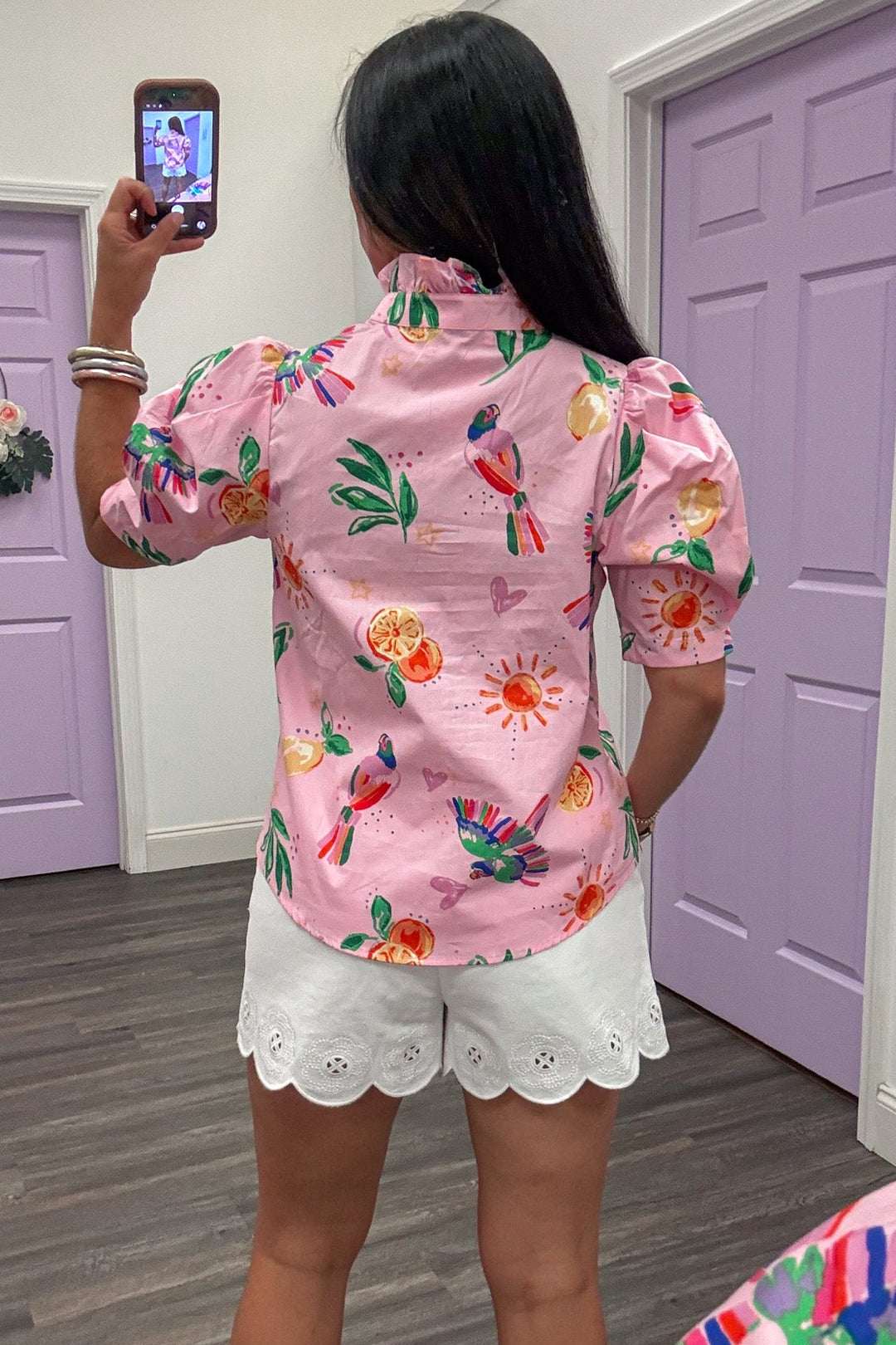 light pink with tropical themed print button down ruffle trimmed mock neck short sleeve top