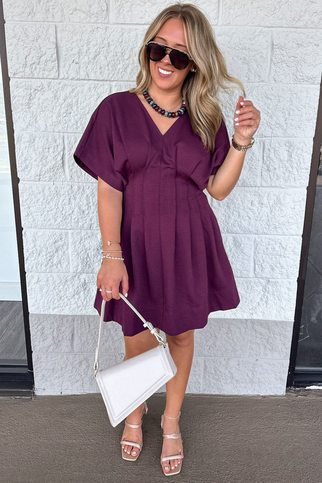 solid plum dolman sleeve v neckline short dress with pleated flowy skirt