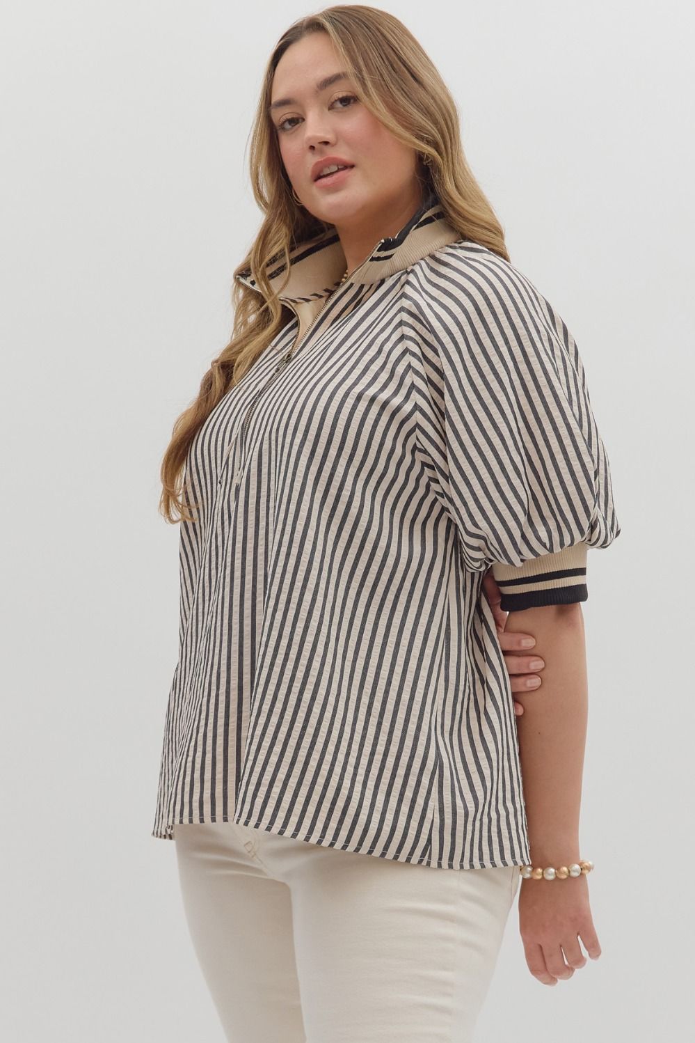 Women's plus black and cream striped top with black and cream ribbed trim detail by Entro showing side view