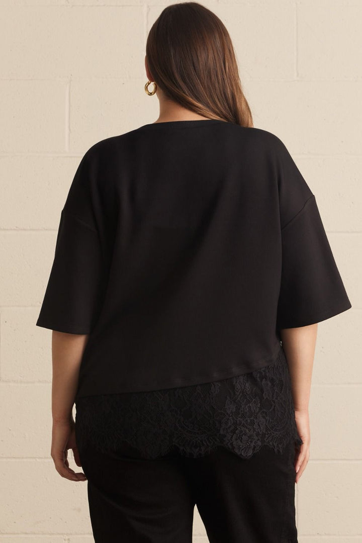 Entro plus size black top with asymmetrical tiered lace detail at the hem in a flattering fit