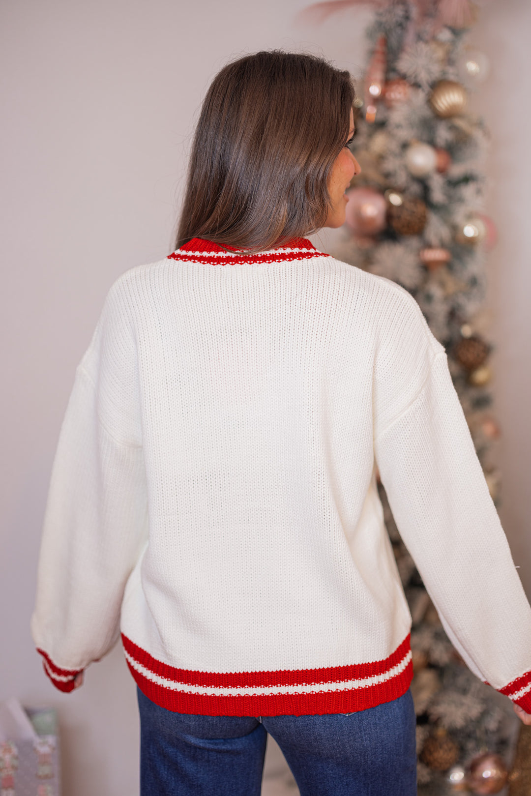 Women's cream sweater with a green plaid Christmas tree and red trim details by Main Strip showing up close back view
