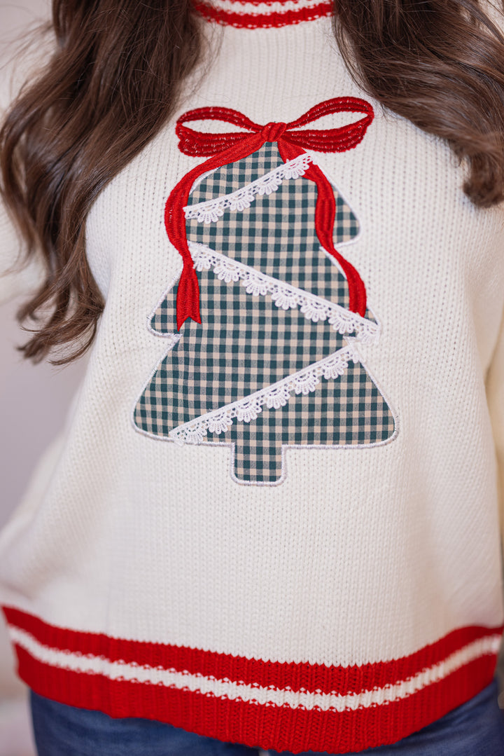 Women's cream sweater with a green plaid Christmas tree and red trim details by Main Strip showing up close bodice view