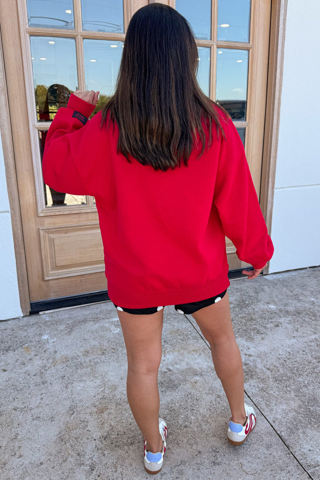 red with black embroidered lulu mac long sleeve crew neckline sweatshirt with banded bottom hem