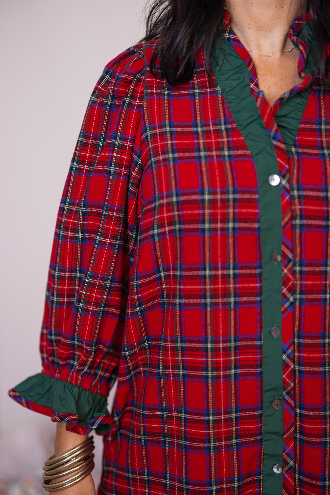 Women's red and green plaid flannel button front dress with ruffle details by Entro showing flannel print