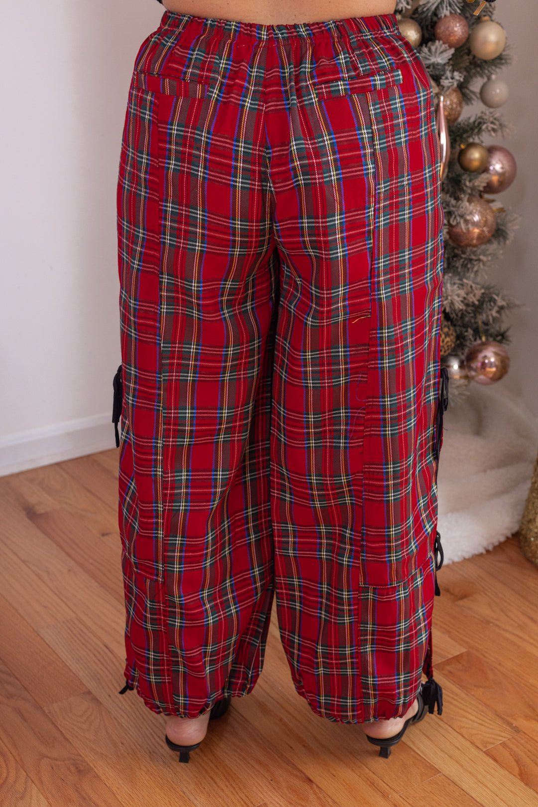 Women's red plaid wide leg adjustable jogger pants with side slits and bow ties by So Me showing up close back view