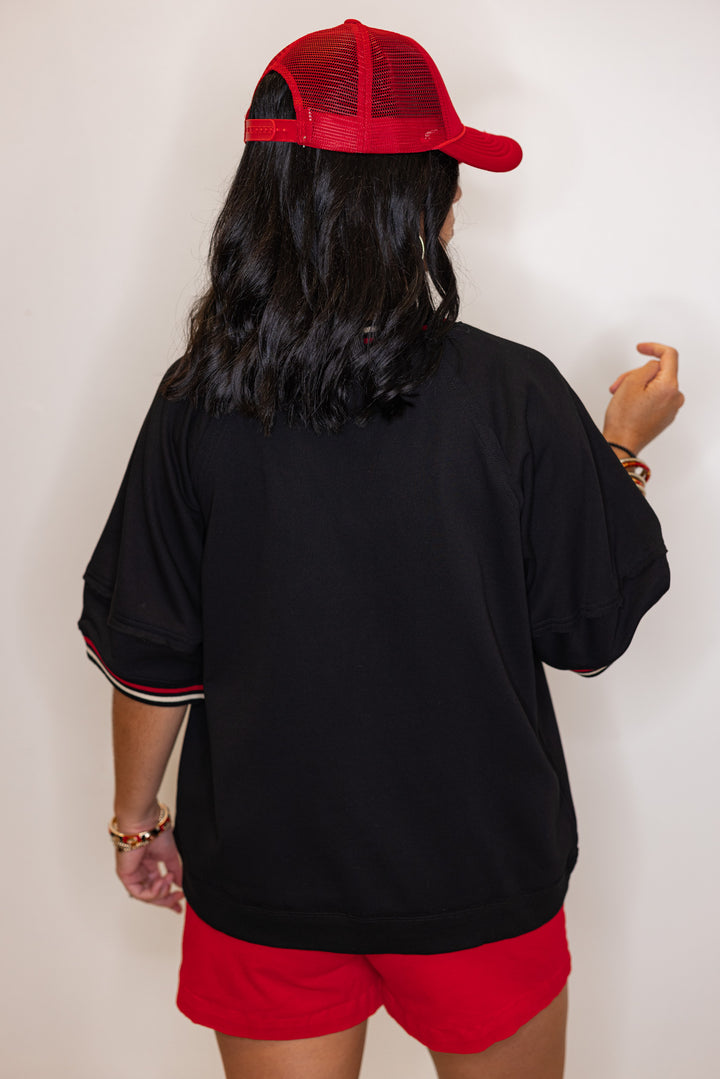 Women's black french terry knit top with cream and red striped trim by Entro showing up close back view