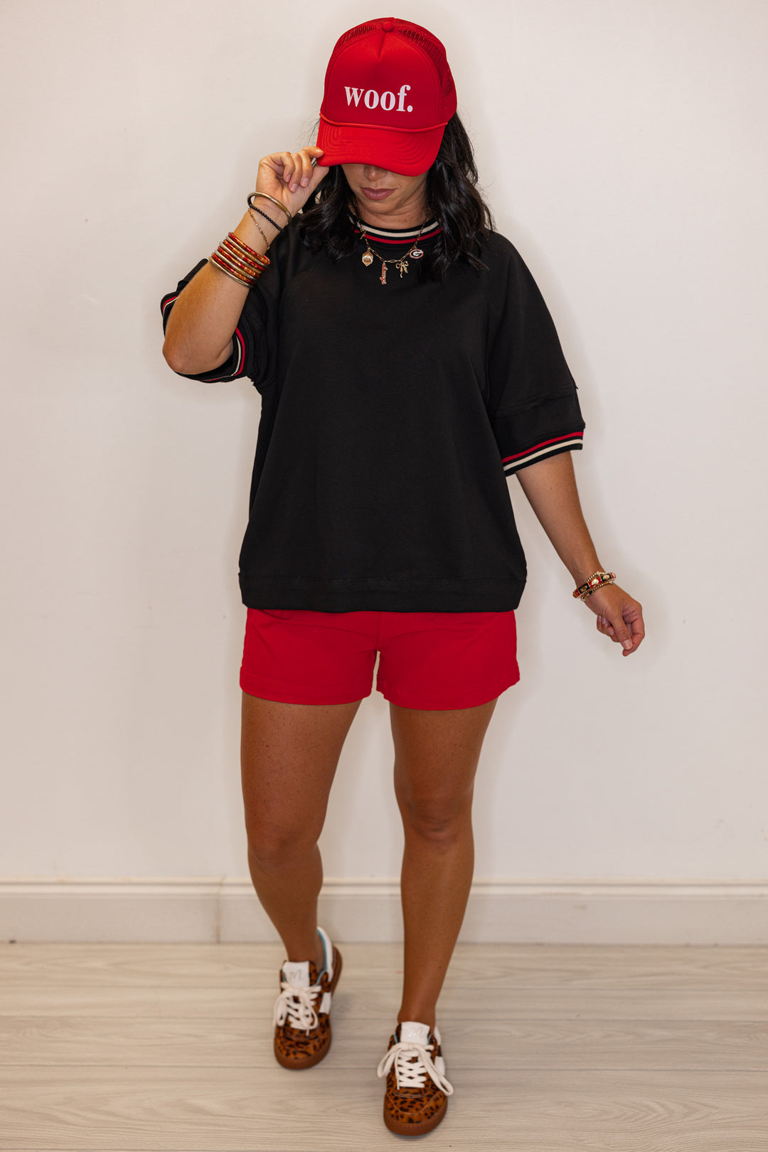 Women's black french terry knit top with cream and red striped trim by Entro showing full front view