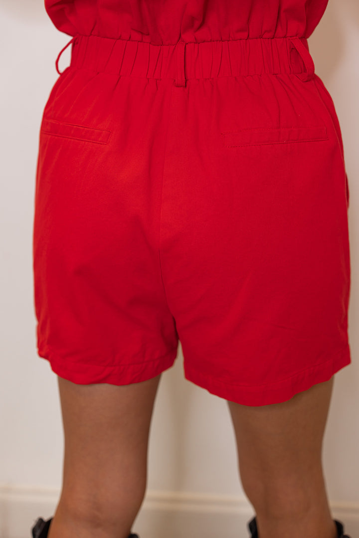 Washed red denim button front sleeveless cargo romperby &merci showing up close back view