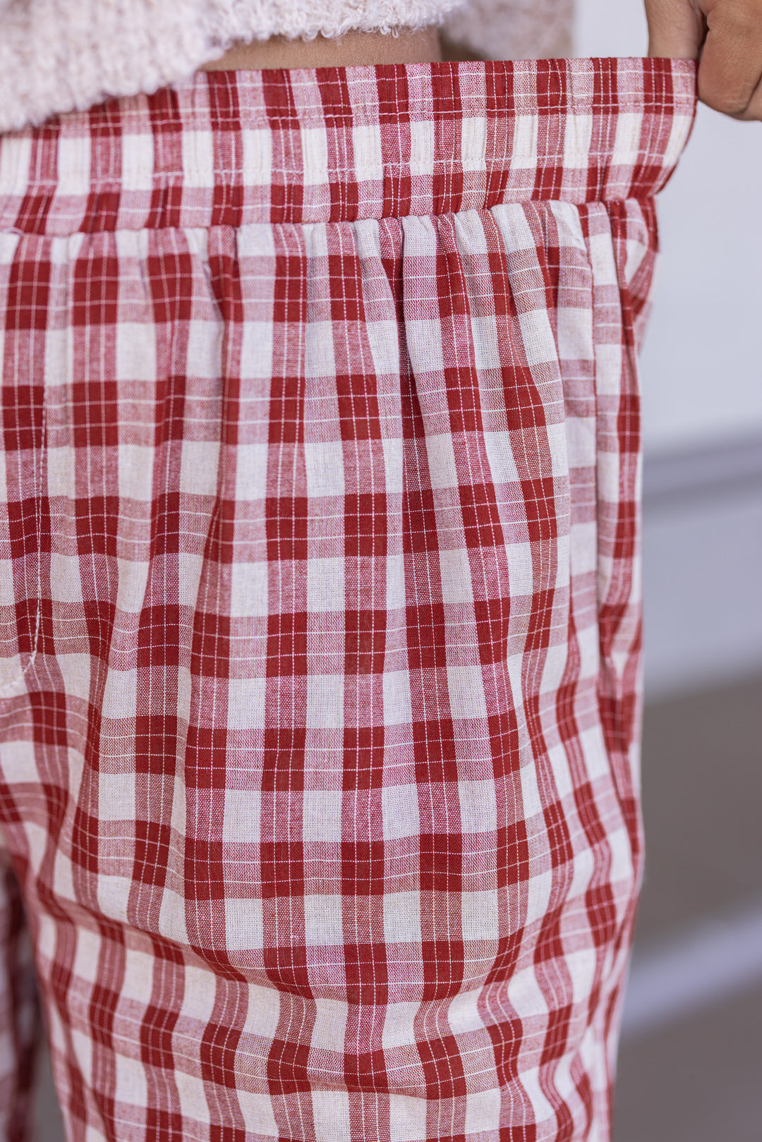 Women's rust and taupe plaid wide leg pants by Wishlist showing elastic waistband