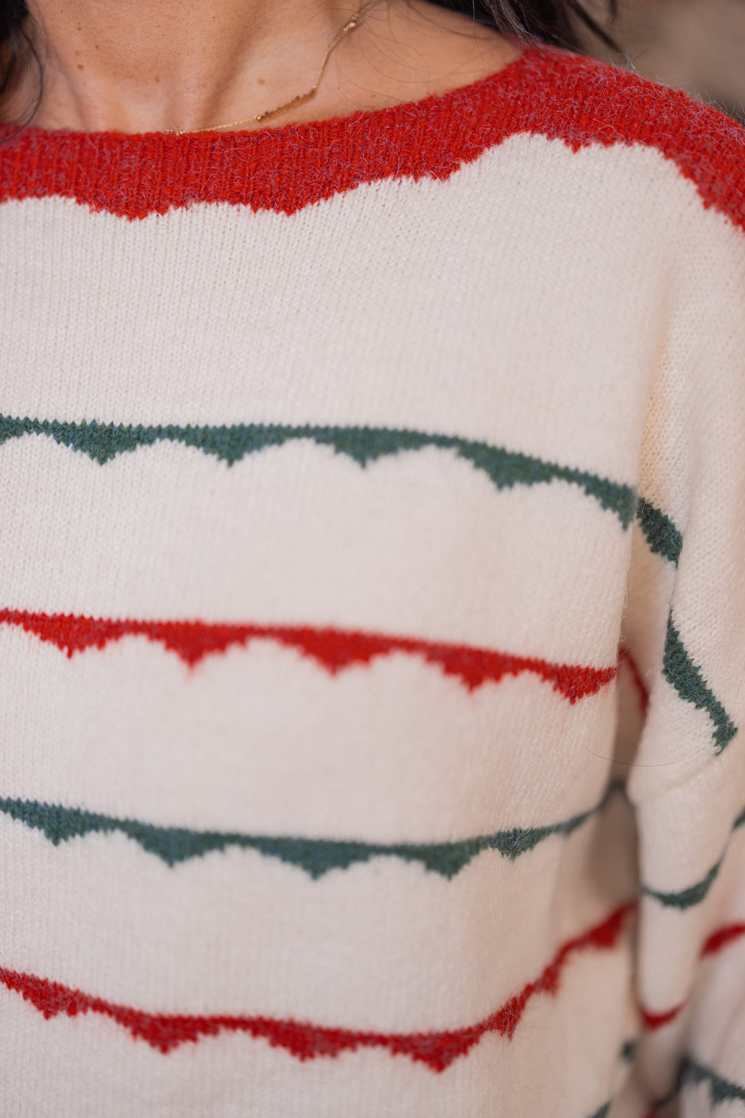 Women's ivory sweater by Peach Love California showing close look at green and red scalloped stripes