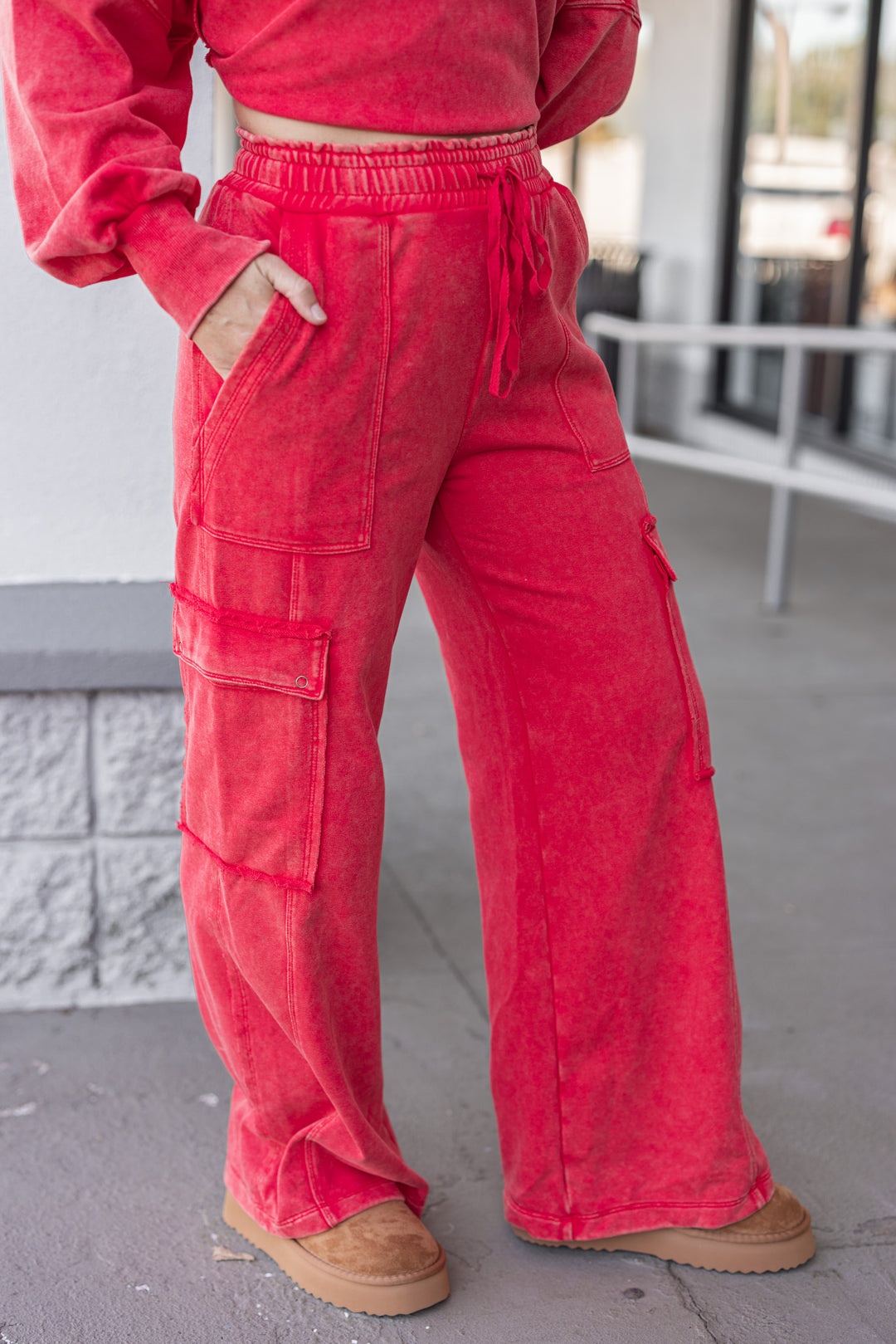 Women's washed red french terry knit wide leg cargo pants by ee:some showing slight side view