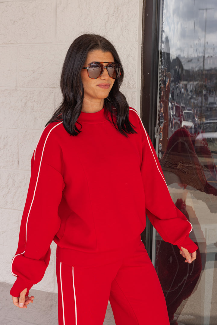 Women's red scuba knit mock neck top by Rae Mode showing up close slight side view