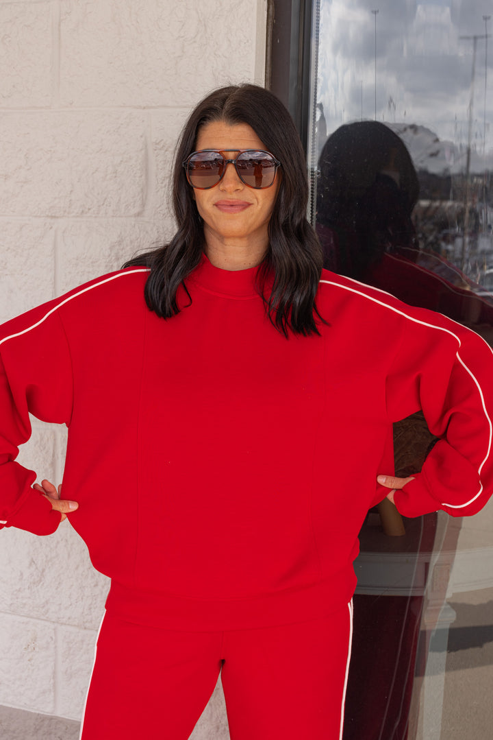 Women's red scuba knit mock neck top by Rae Mode showing true to size fit